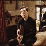 Serge Gainsbourg (Eric Elmosnino) with guitar in ‘Gainsbourg: A Heroic Life.’ Film still courtest of Music Box Films.