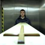 Roman (Thomas Schubert) in ‘Breathing’ with coffin. Image courtesy of Kino Lorber